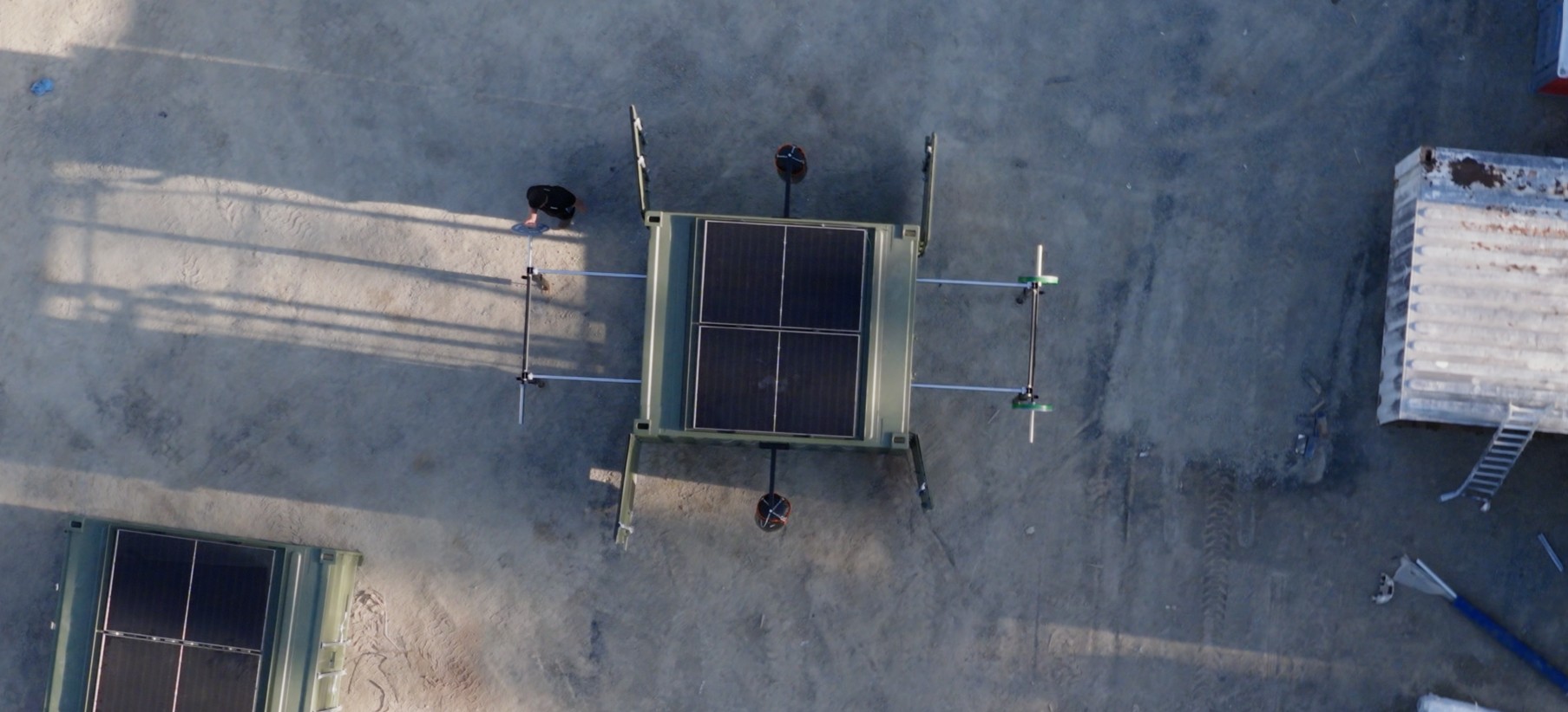 Overhead view of a FORCES Rapid system with roof-mounted solar panels and external training stations